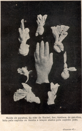 materialized objects in plaster having been captured in paraffin wax moulds: a hand, flower, and sitters handkerchiefsf said to have been knotted by João 