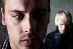 photograph of man being stared at from behind